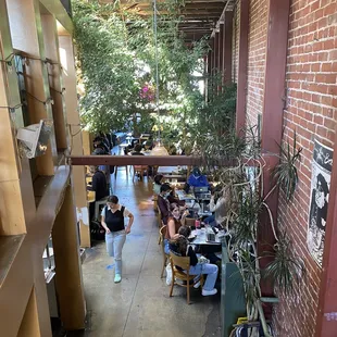people sitting at tables in a cafe