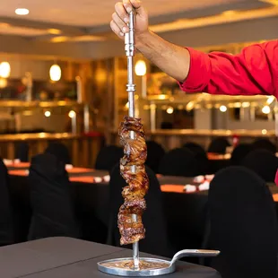 12 different types of meat which are presented on skewers and carved table side. www.cafemineirosteakhouse.com