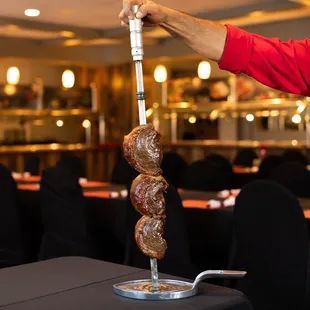 12 different types of meat which are presented on skewers and carved table side. www.cafemineirosteakhouse.com