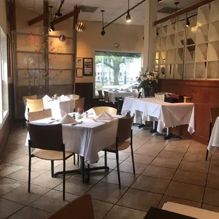 tables and chairs with white tablecloths