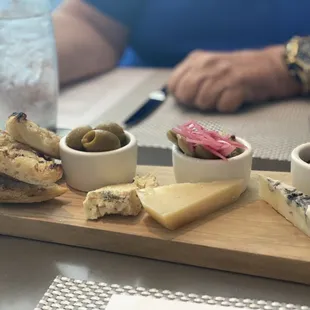 cheese, crackers, olives, and bread