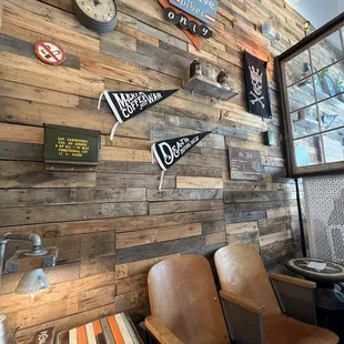 a wooden wall with signs on it