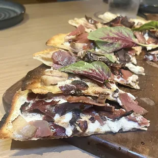 The Cure flatbread - duck and lamb speck, whipped goat, arugula, lemon vinaigrette, balsamic