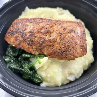a fish fillet with mashed potatoes and spinach
