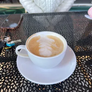 a cup of cappuccino on a table