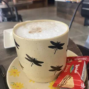 a cup of cappuccino and a snack