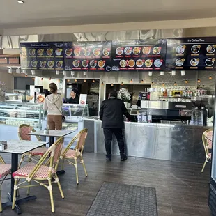 a man and a woman standing in front of the counter