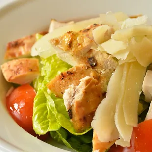 a salad with chicken and tomatoes