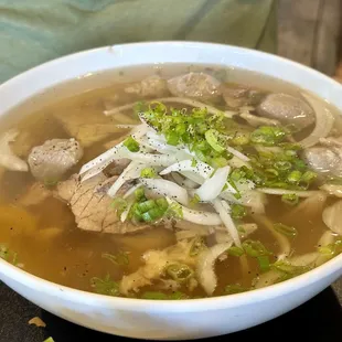 Phở Dac Biet (beef based soup with sliced round-eye steak, beef brisket, beef meatballs, and tendon)