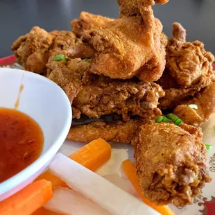 a plate of fried chicken and carrots