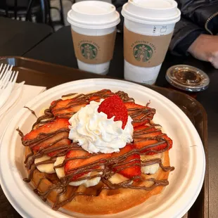 a waffle with strawberries and whipped cream