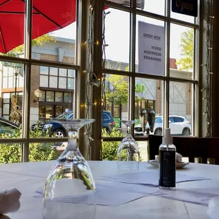 a table with wine glasses and an umbrella