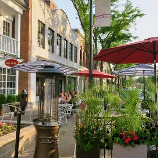 tables and umbrellas on a sidewalk