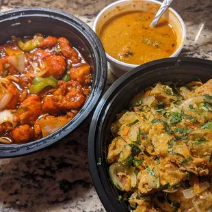 Food to go: chilli curry (red), kothu roti (bottom right), which came with chicken curry (top) to top it with.