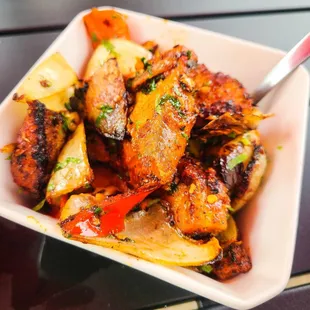 a bowl of chicken wings and potatoes