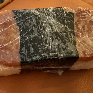 a sandwich wrapped in plastic wrap