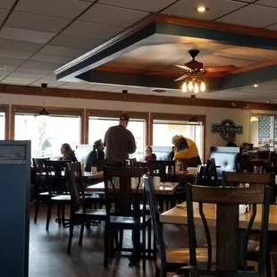 people sitting at tables in a restaurant