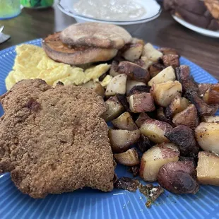 Country fried steak and eggs with sausage gravy. Delicious.