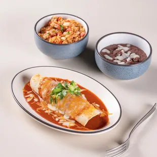 Enchilada with a side of beans and rice