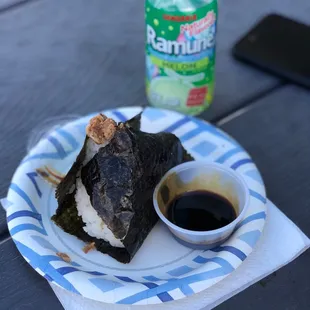 a plate of sushi and a bottle of ketchup