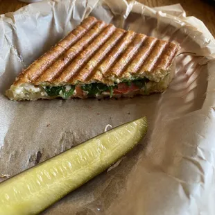 a grilled sandwich and a pickle