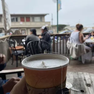 a person holding a cup of coffee