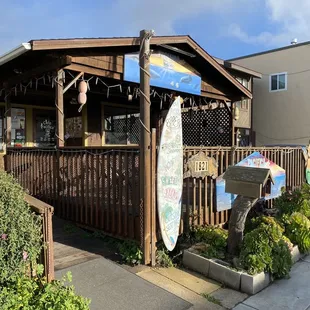 a surfboard leaning against a fence