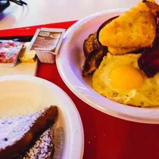 a bowl of eggs and toast on a red tray