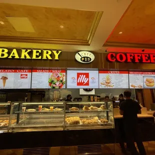 a bakery counter with a variety of pastries