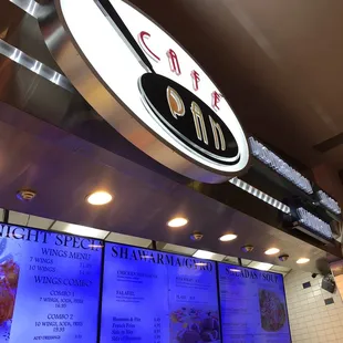menus and a clock above the counter