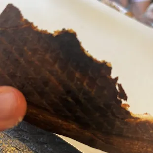 a hand holding a piece of bread