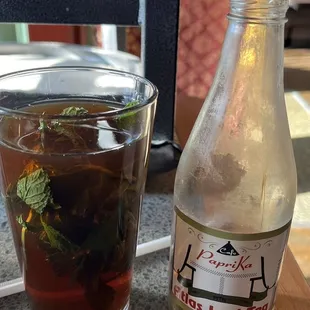 a glass of tea and a bottle of tea