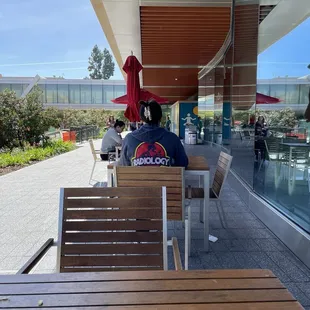 Several tables outside and a few chairs and booths inside