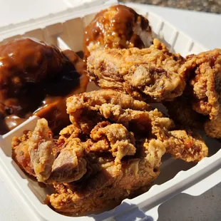 a container of fried chicken and donuts