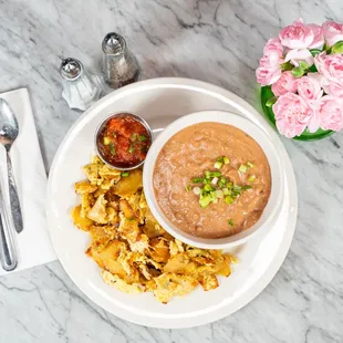 Golden crisp corn tortillas sauteed with scrambled eggs. Served with refried beans and home-made salsa.
