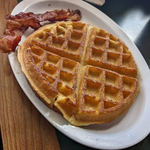 a waffle and bacon on a plate
