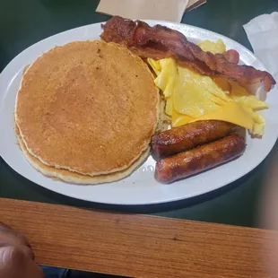 Pancakes bacon sausage and eggs.