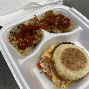 Sausage egg and cheese (with tomatoes) on an English muffin served with Home Fries
