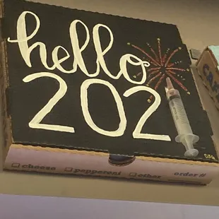 The walls are decorated with painted pizza boxes.  This made me laugh given the vaccination rollout this year.
