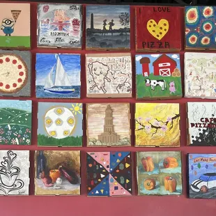 Wall art full of decorated pizza boxes