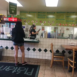 a woman standing at a counter