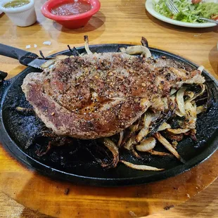 a large steak on a grill