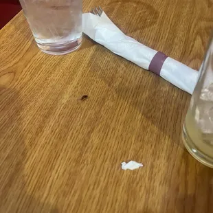 A baby roach crawling on the table near my food.