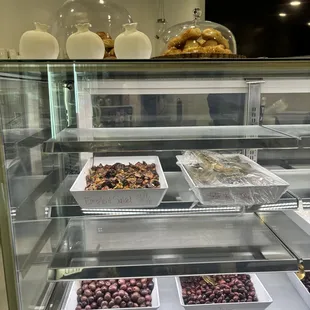 a display case with a variety of desserts