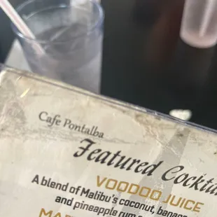 a menu and a glass of water