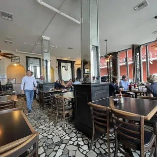 people sitting at tables in a restaurant