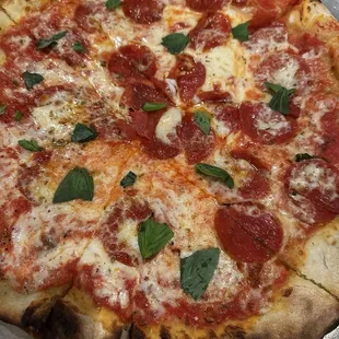 Pepperoni pizza with basil