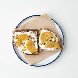 two slices of toast with cream and fruit