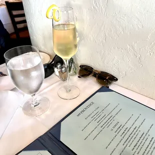 a glass of wine and menu