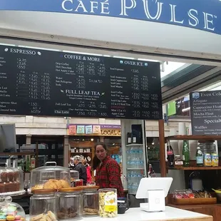 a woman behind the counter of a cafe